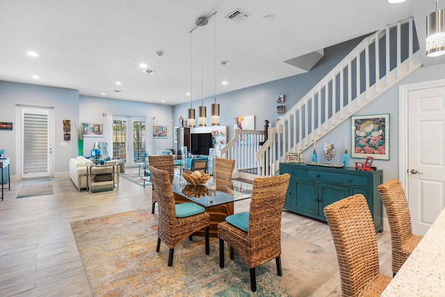 dining space with visible vents, stairway, recessed lighting, light wood finished floors, and french doors