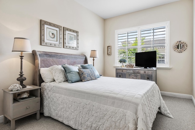 carpeted bedroom with baseboards