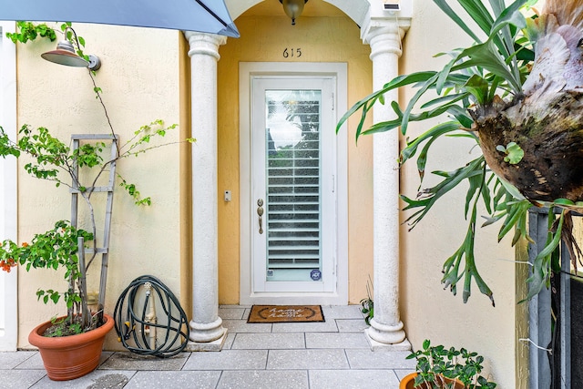 entrance to property featuring stucco siding