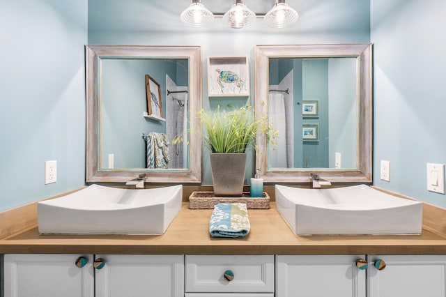 full bath featuring double vanity and a sink