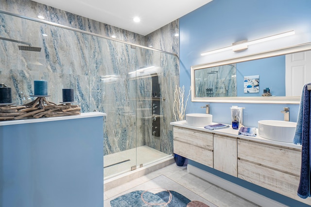full bathroom featuring recessed lighting, double vanity, a sink, and a marble finish shower