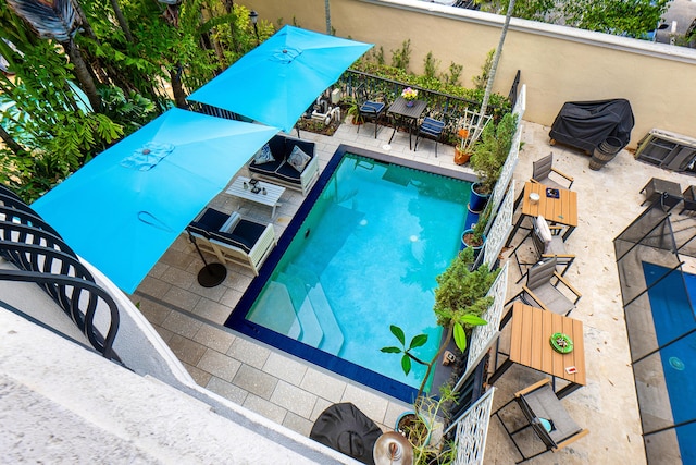 view of swimming pool featuring a patio area