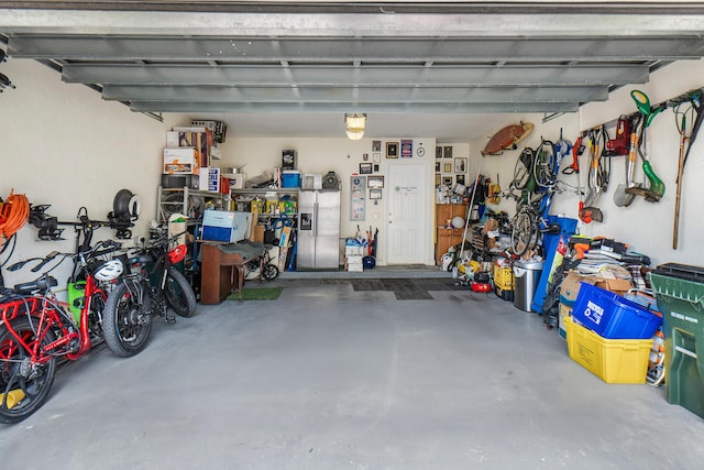 garage featuring stainless steel fridge with ice dispenser