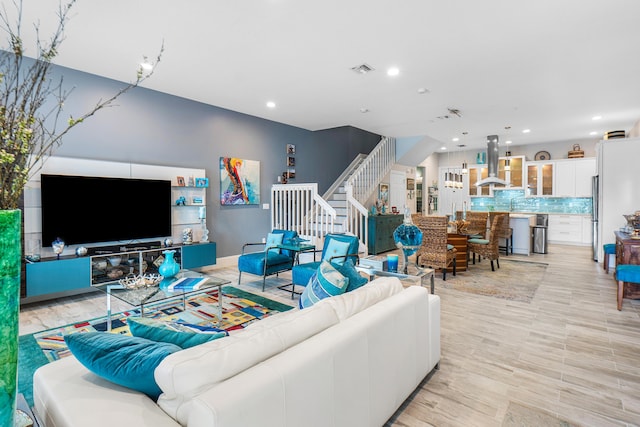 living area featuring recessed lighting, stairs, and visible vents