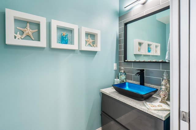 bathroom with decorative backsplash and vanity