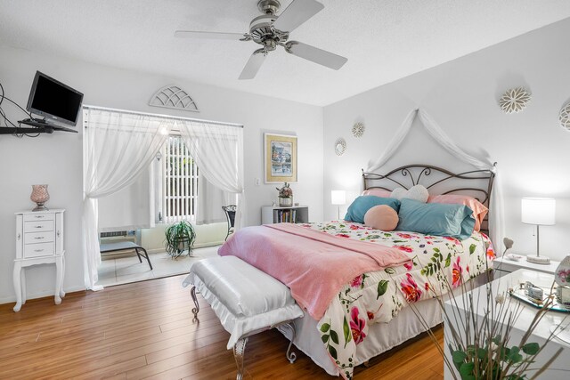 309 Sheffield M Unit 309, West Palm Beach, FL 33417 - bedroom featuring access to exterior, ceiling fan, and wood finished floors