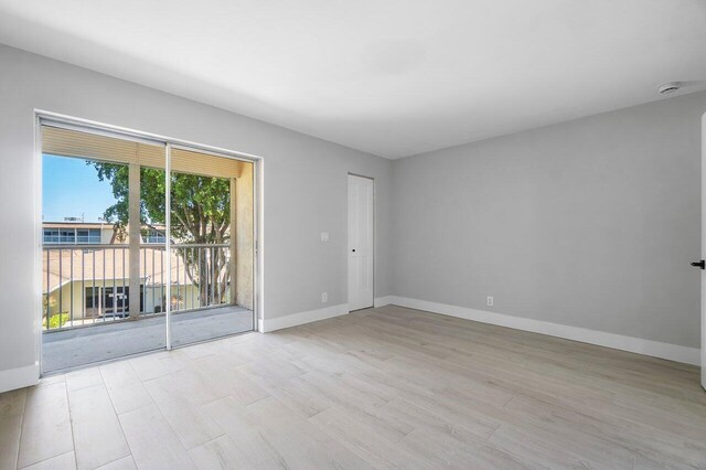 400 Village Green Cir W Unit 310, Palm Springs, FL 33461 - unfurnished room featuring light wood-type flooring, visible vents, and baseboards