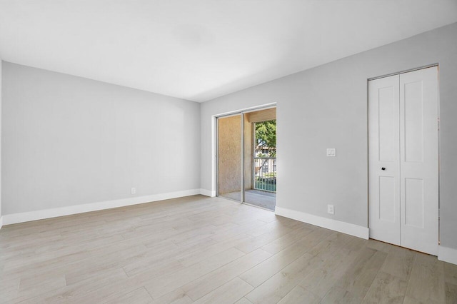 400 Village Green Cir W Unit 310, Palm Springs, FL 33461 - unfurnished room with baseboards and light wood-style flooring