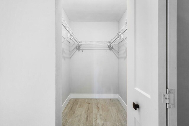 400 Village Green Cir W Unit 310, Palm Springs, FL 33461 - unfurnished room with baseboards and light wood-style flooring