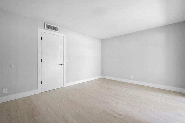 400 Village Green Cir W Unit 310, Palm Springs, FL 33461 - spare room with baseboards, light wood finished floors, and visible vents