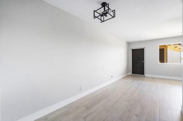 400 Village Green Cir W Unit 310, Palm Springs, FL 33461 - unfurnished room featuring baseboards and light wood-type flooring
