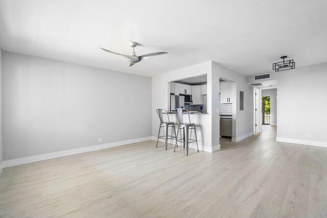 400 Village Green Cir W Unit 310, Palm Springs, FL 33461 - empty room featuring baseboards, wood finished floors, and a ceiling fan