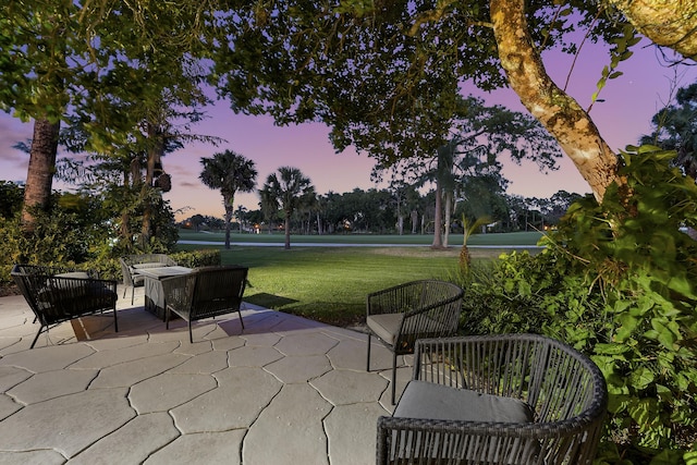 13810 Crosspointe Ct, Palm Beach Gardens, FL 33418 - patio terrace at dusk with a lawn