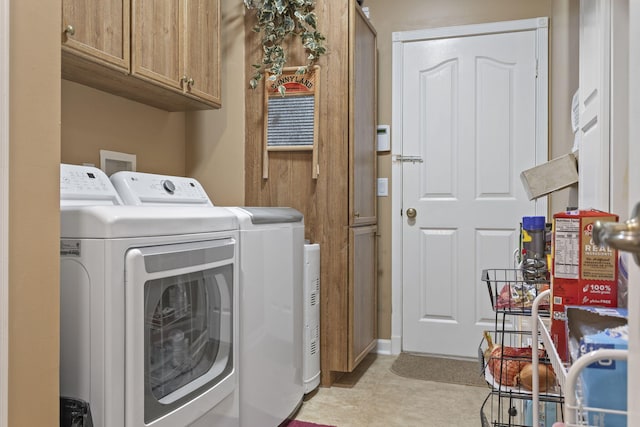 washroom with cabinet space and separate washer and dryer
