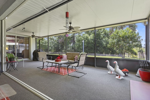 sunroom / solarium with ceiling fan and an outdoor hangout area