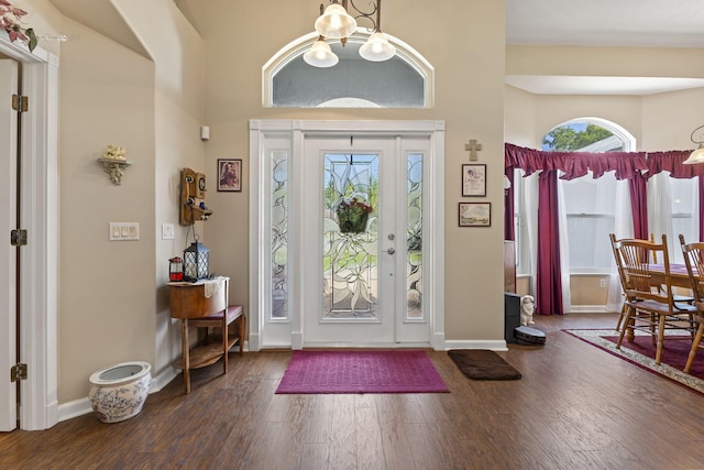 foyer entrance featuring baseboards and wood finished floors