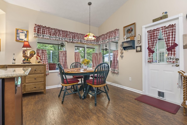 dining space with baseboards, lofted ceiling, dark wood finished floors, and visible vents