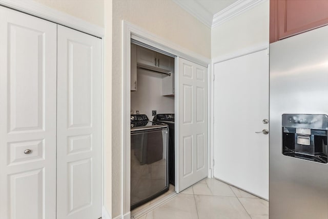 kitchen featuring washer and clothes dryer, ornamental molding, and stainless steel fridge