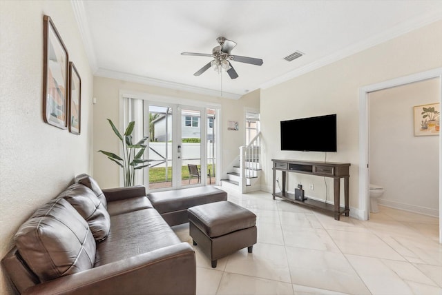 living area featuring visible vents, light tile patterned floors, ornamental molding, ceiling fan, and stairway