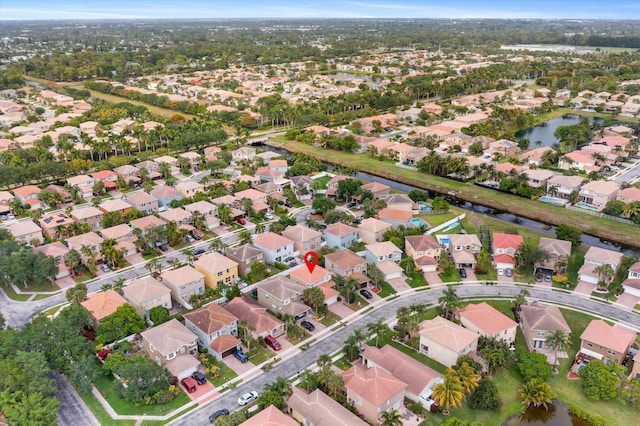 birds eye view of property with a water view and a residential view