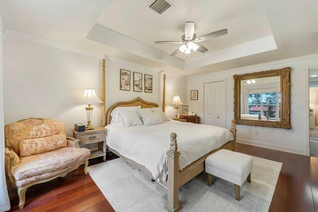 273 River Bluff Ln, Royal Palm Beach, FL 33411 - bedroom featuring a raised ceiling, wood finished floors, crown molding, a closet, and ceiling fan