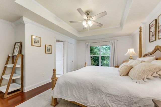273 River Bluff Ln, Royal Palm Beach, FL 33411 - bedroom featuring dark wood-type flooring, a raised ceiling, ornamental molding, a ceiling fan, and baseboards