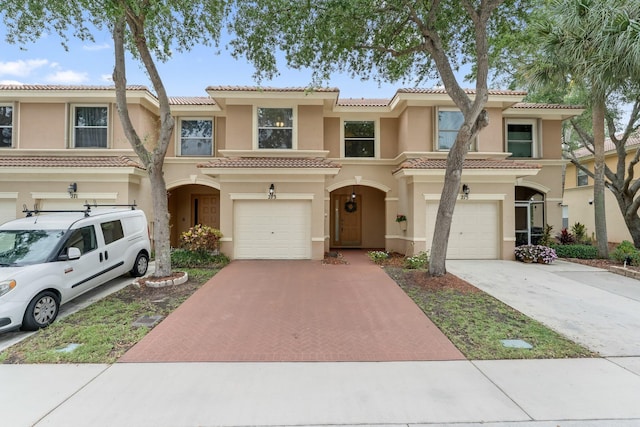 273 River Bluff Ln, Royal Palm Beach, FL 33411 - view of property featuring decorative driveway, stucco siding, and an attached garage