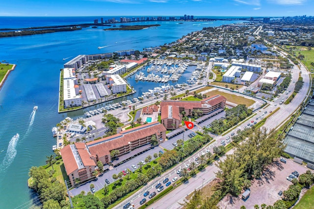 drone / aerial view featuring a view of city and a water view