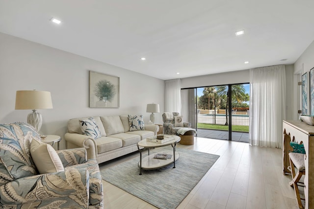 living area featuring recessed lighting and light wood finished floors