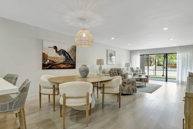 dining space with recessed lighting and light wood finished floors