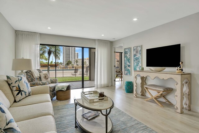 living area with recessed lighting and light wood-style flooring