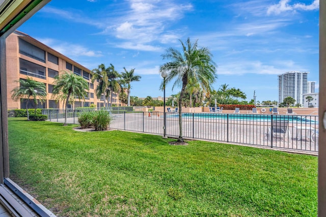 pool with a yard and fence