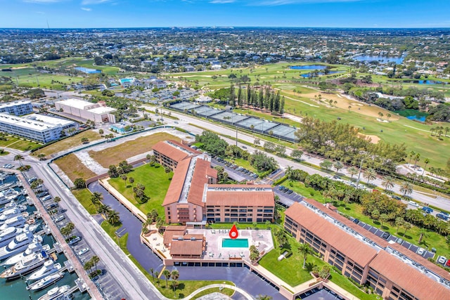 drone / aerial view featuring view of golf course and a water view
