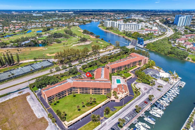 drone / aerial view featuring a view of city, a water view, and golf course view