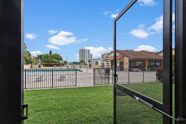 pool with a yard, fence, and a patio area