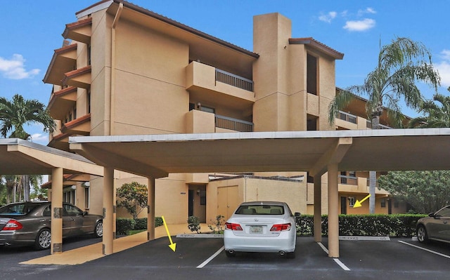 view of building exterior featuring covered parking