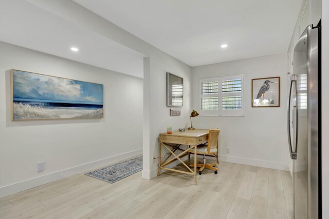 living area with recessed lighting, baseboards, and light wood-type flooring