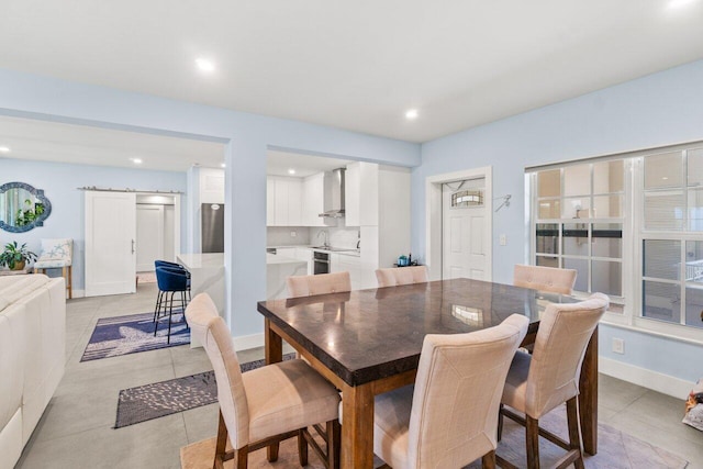 dining room with light tile patterned flooring and recessed lighting