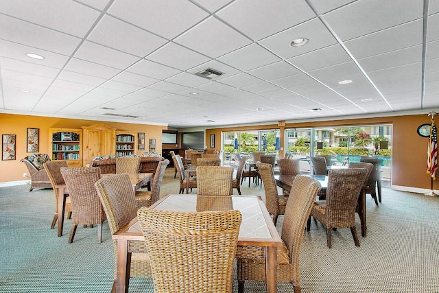dining area featuring a wealth of natural light, carpet, visible vents, and baseboards