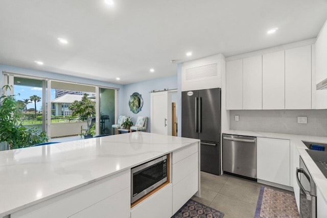 kitchen with modern cabinets, white cabinets, and stainless steel appliances