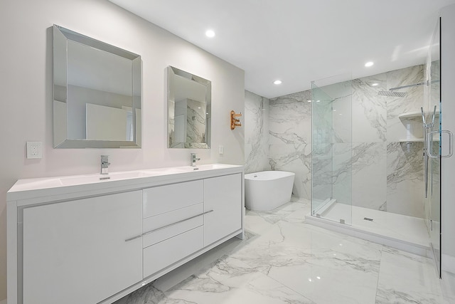 full bath with a sink, a marble finish shower, a freestanding bath, and marble finish floor