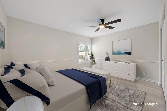 bedroom featuring baseboards, a ceiling fan, and wood finished floors