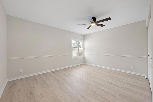 spare room with light wood-style floors, baseboards, and ceiling fan