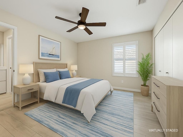 bedroom featuring baseboards, a closet, light wood-type flooring, and visible vents