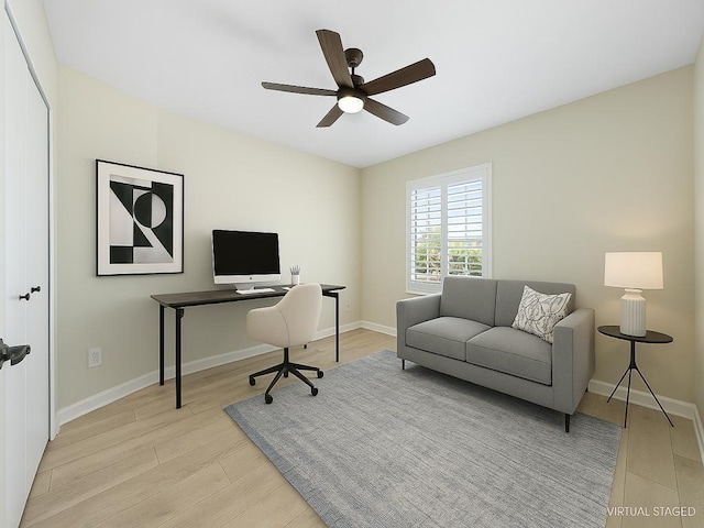 home office featuring baseboards, ceiling fan, and wood finished floors