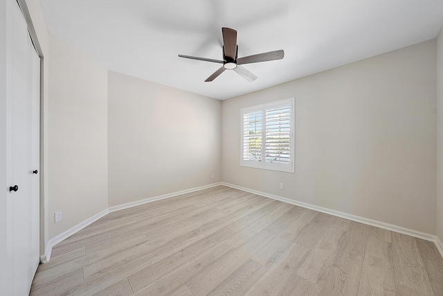 empty room with light wood-style floors, baseboards, and a ceiling fan