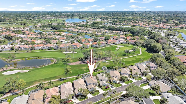 birds eye view of property with a residential view, a water view, and golf course view