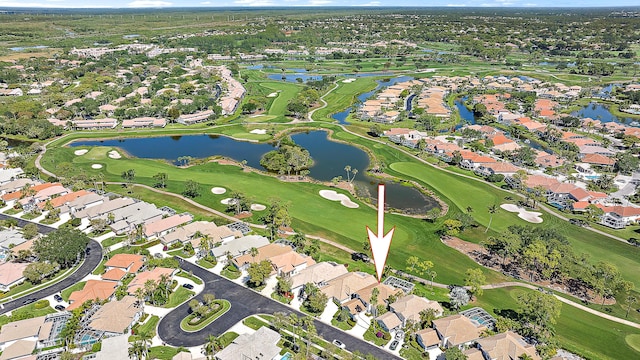 aerial view with a water view, view of golf course, and a residential view