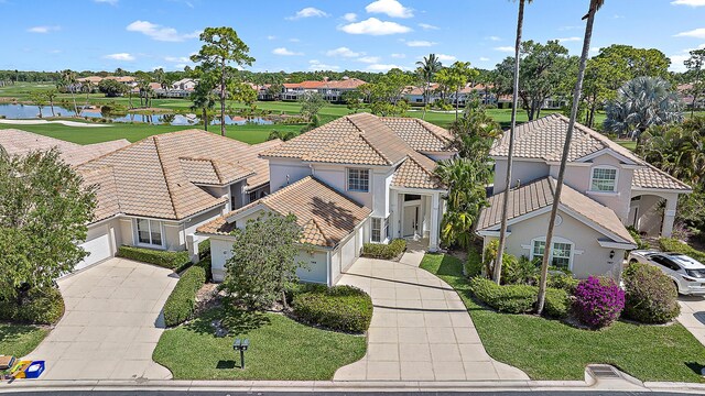 drone / aerial view with a water view and a residential view