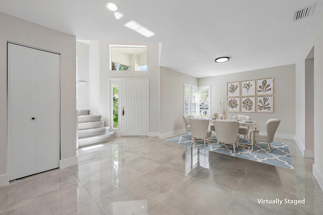 entryway featuring stairway, baseboards, and visible vents